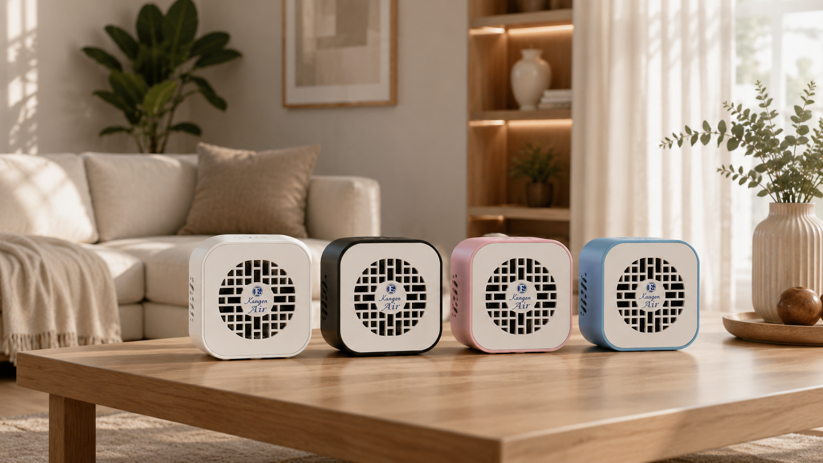 Four Kangen Air purifiers in white, black, pink and blue on a wooden table